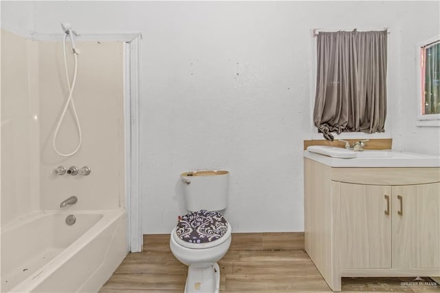 2606 Lissner Ave, Donna, TX 78537 - full bath with vanity, shower / bathtub combination, wood finished floors, and toilet