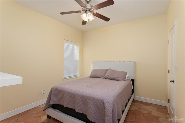 tiled bedroom featuring ceiling fan