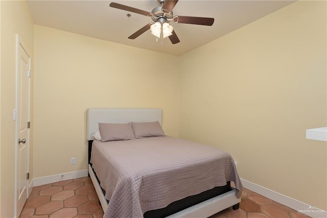 bedroom with ceiling fan and light tile patterned flooring