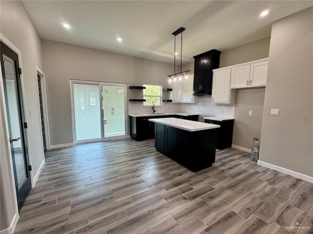 209 S Raul Longoria Rd, Edinburg, TX 78542 - kitchen with a kitchen island, open shelves, a sink, light countertops, and baseboards