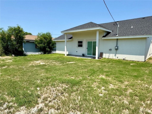 209 S Raul Longoria Rd, Edinburg, TX 78542 - back of property featuring a lawn and a shingled roof