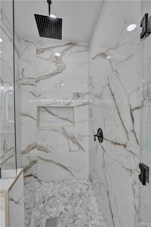 bathroom with a marble finish shower