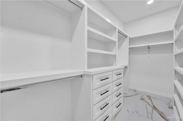 spacious closet with marble finish floor