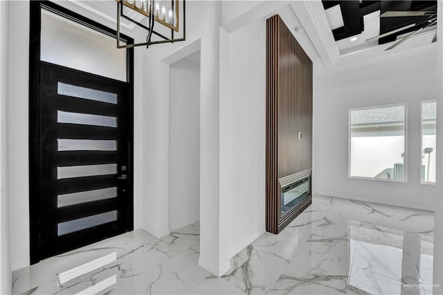 entryway with baseboards, marble finish floor, an inviting chandelier, crown molding, and recessed lighting