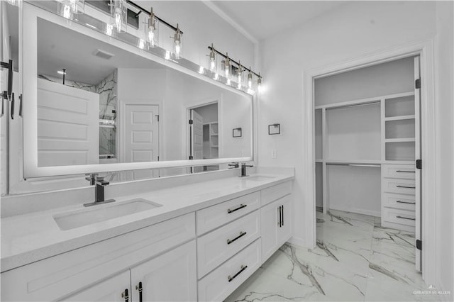 bathroom featuring marble finish floor, a sink, a spacious closet, and a marble finish shower