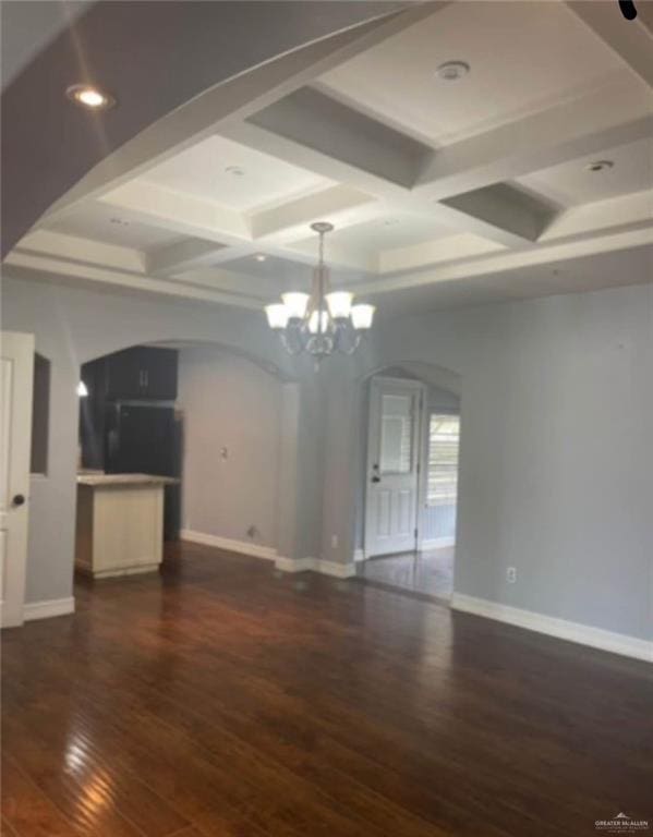 1516 S 14th Ave, Edinburg, TX 78539 - unfurnished living room featuring arched walkways, coffered ceiling, a chandelier, dark wood finished floors, and baseboards