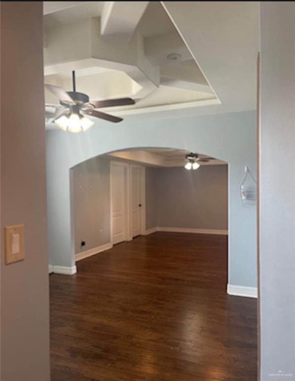 1516 S 14th Ave, Edinburg, TX 78539 - unfurnished room featuring a ceiling fan, dark wood-style flooring, baseboards, and arched walkways