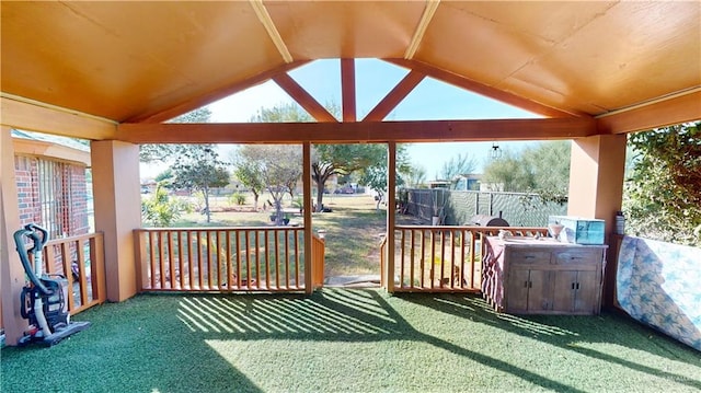 wooden terrace with a lawn