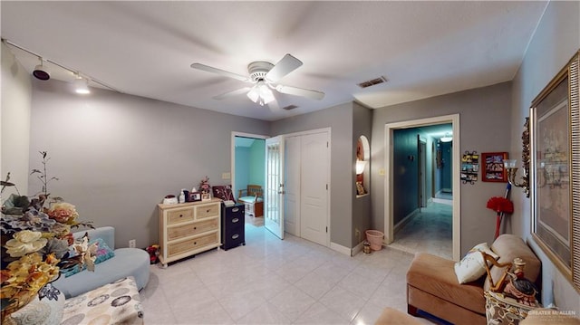 sitting room featuring ceiling fan and rail lighting