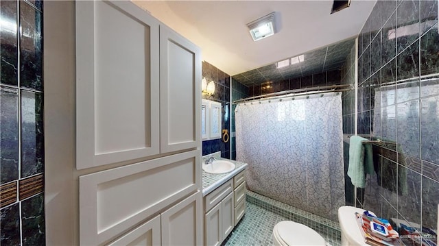 bathroom featuring tile patterned floors, walk in shower, vanity, and toilet