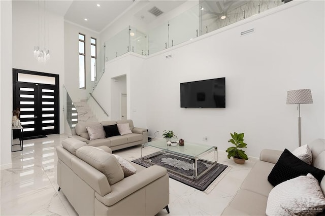 living room with a towering ceiling and french doors