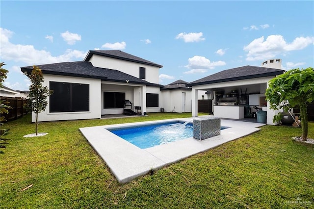 rear view of house with a lawn, area for grilling, and a patio area