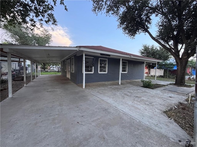 1012 S Inspiration Rd, Mission, TX 78573 - property exterior at dusk featuring fence, an attached carport, driveway, and stucco siding