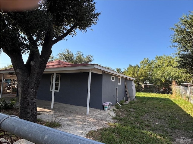1012 S Inspiration Rd, Mission, TX 78573 - view of side of property featuring stucco siding and a patio