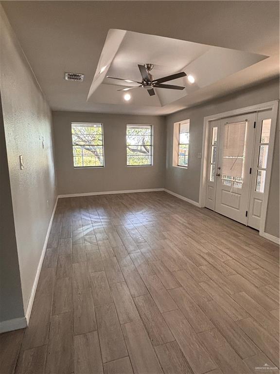 1012 S Inspiration Rd, Mission, TX 78573 - foyer featuring a raised ceiling, wood finished floors, and baseboards