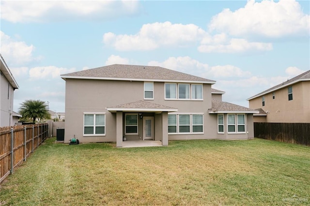 rear view of property featuring a yard and a patio