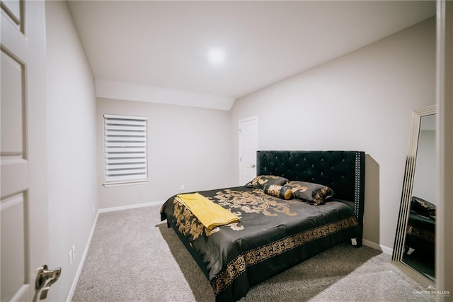 carpeted bedroom with lofted ceiling