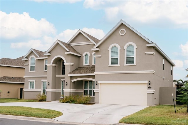 view of front facade featuring a garage and a front lawn