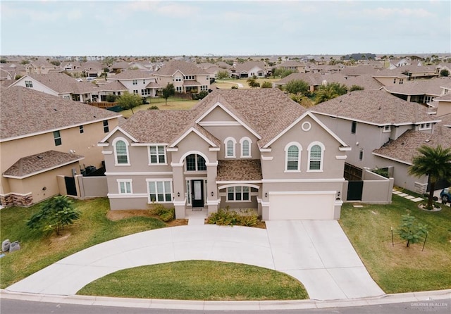 view of front of house featuring a garage and a front lawn