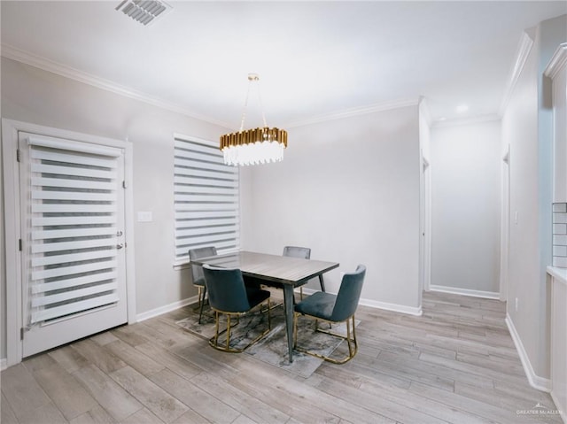 dining area with light hardwood / wood-style flooring and ornamental molding