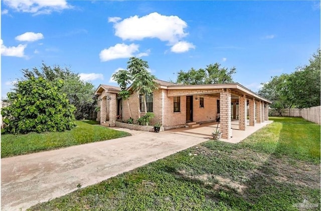 view of front of house with a front lawn and a carport