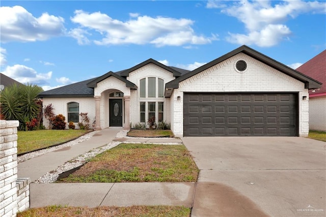 view of front of house featuring a front yard and a garage