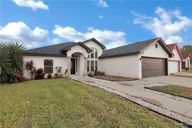 view of front of home with a front lawn and a garage