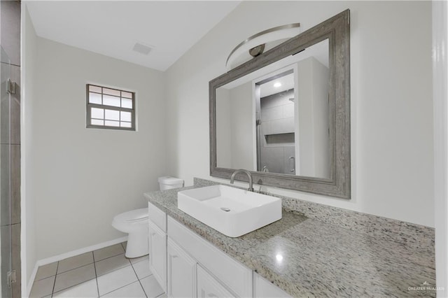 bathroom with toilet, vanity, tile patterned floors, and a shower with shower door