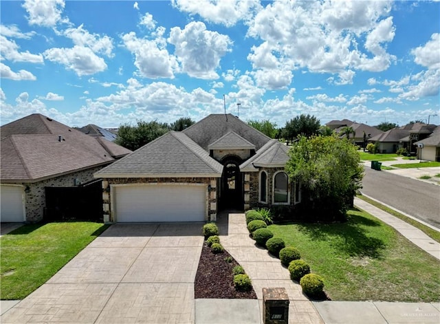 view of front of house featuring a garage and a front lawn