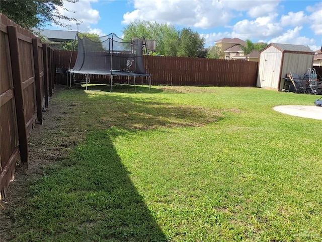 view of yard with a storage unit and a trampoline