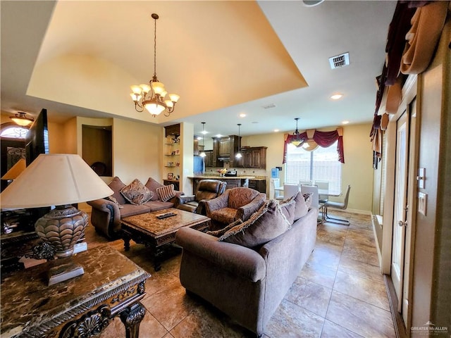 tiled living room with a raised ceiling and a chandelier