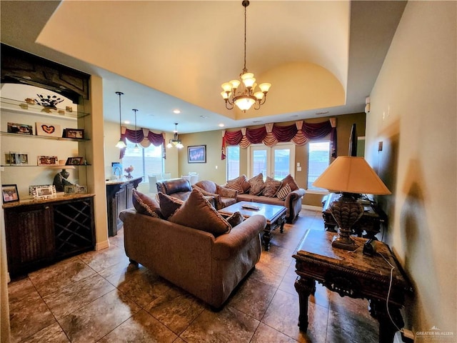 tiled living room with a healthy amount of sunlight and an inviting chandelier