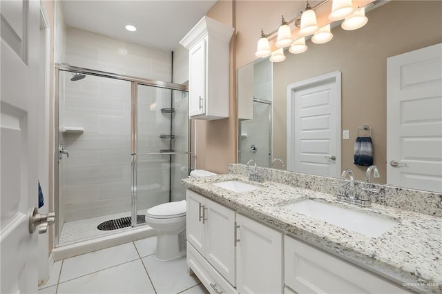 full bathroom featuring tile patterned flooring, a sink, and a stall shower