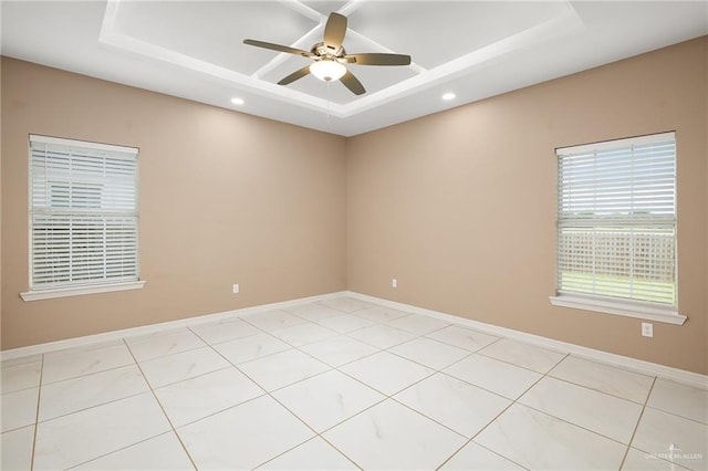 unfurnished room featuring a ceiling fan, a tray ceiling, recessed lighting, and light tile patterned floors