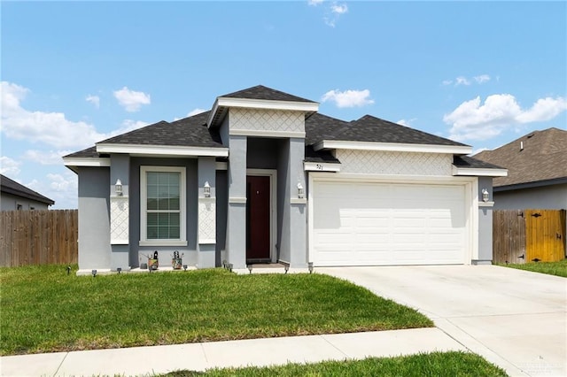prairie-style house featuring an attached garage, fence, and stucco siding