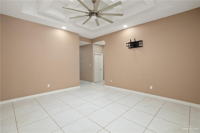 empty room featuring a raised ceiling, ceiling fan, recessed lighting, and light tile patterned flooring