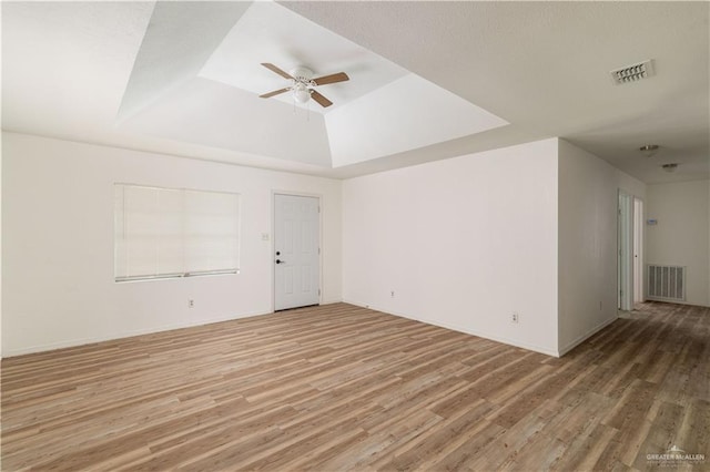420 N Beto Garcia Dr, Weslaco, TX 78596 - spare room featuring a raised ceiling, light wood-style floors, and ceiling fan