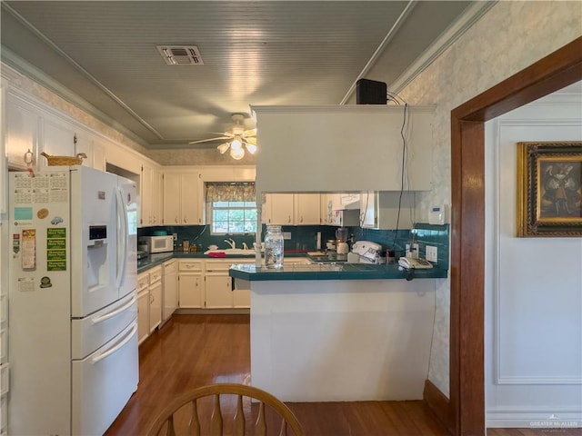 415 S Glasscock Blvd, Mission, TX 78573 - kitchen featuring white appliances, tile counters, dark wood-style floors, white cabinetry, and ornamental molding