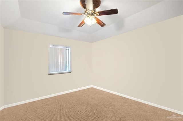 spare room with ceiling fan, carpet, and a raised ceiling