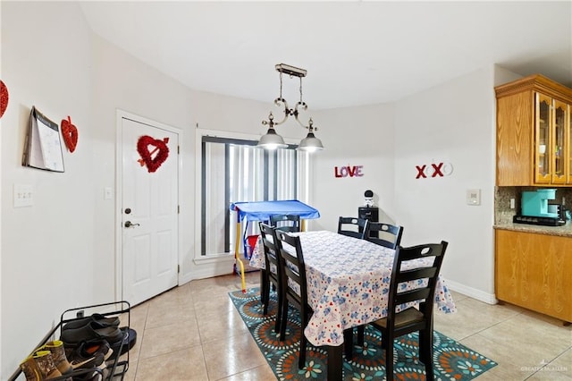 dining space featuring light tile patterned floors