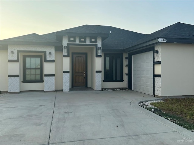 exterior entry at dusk with a garage