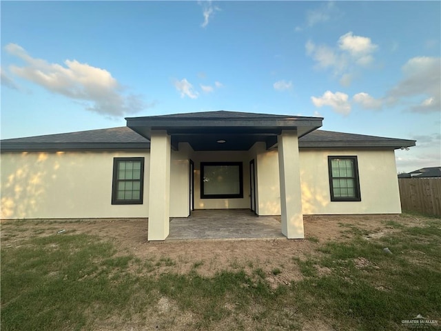 back of house featuring a patio area and a yard