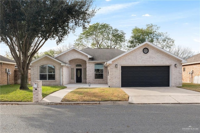 single story home with a garage and a front lawn