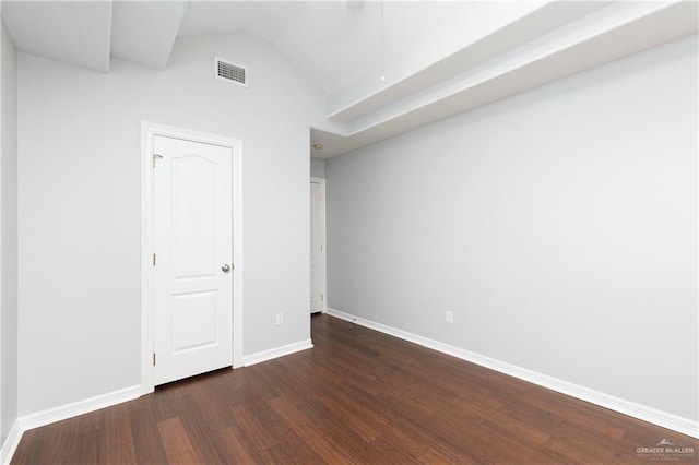 interior space with lofted ceiling and dark wood-type flooring