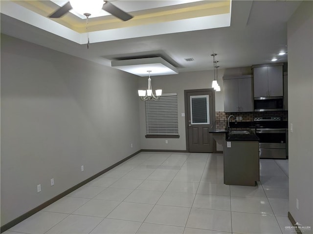 4012 Whitewing Ave, Edinburg, TX 78539 - kitchen featuring dark countertops, a sink, ceiling fan with notable chandelier, stainless steel appliances, and tasteful backsplash