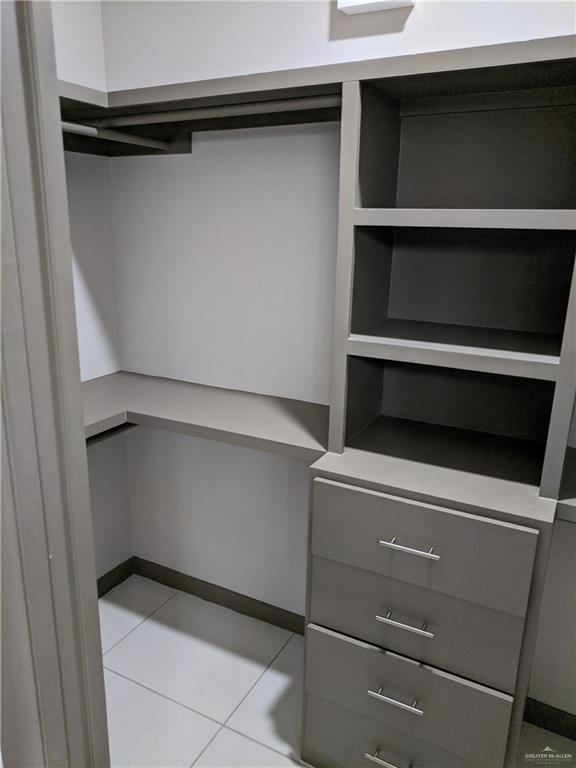 4012 Whitewing Ave, Edinburg, TX 78539 - walk in closet featuring light tile patterned floors
