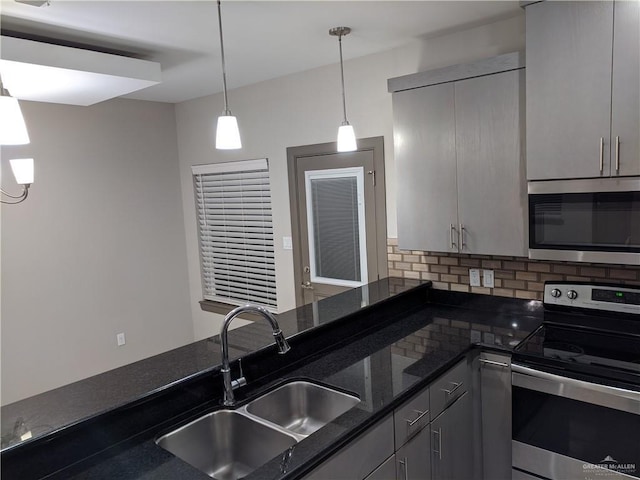 4012 Whitewing Ave, Edinburg, TX 78539 - kitchen featuring decorative backsplash, gray cabinets, a sink, decorative light fixtures, and stainless steel appliances