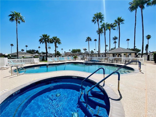 view of pool with a hot tub and a patio area