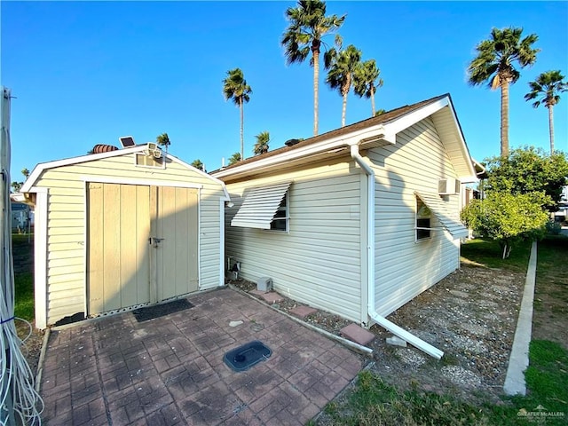 exterior space with a shed and a patio area