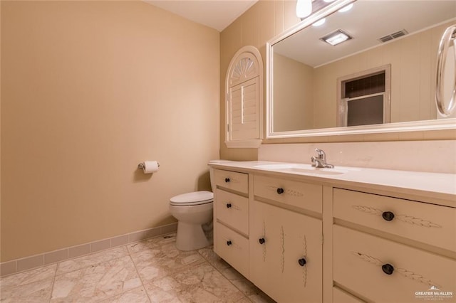 full bathroom with toilet, vanity, visible vents, baseboards, and marble finish floor